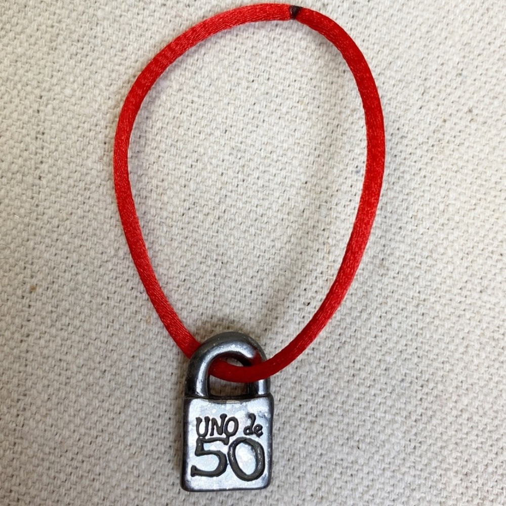 UNO de 50 silver lock charm with red cord